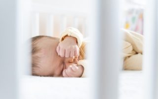 Baby Sleeps With Hands Behind Their Head