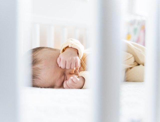 Baby Sleeps With Hands Behind Their Head