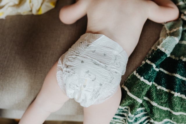 Baby Boy Peeing Out Back Of Diaper