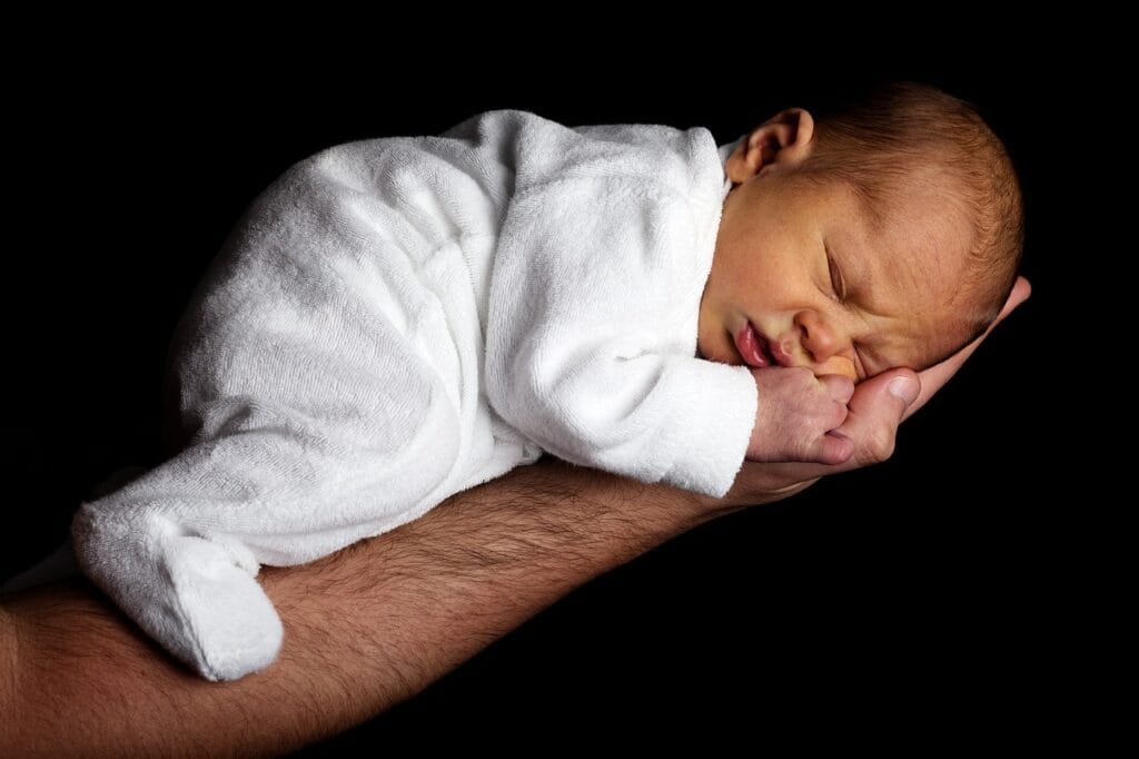 newborn spitting up clear liquid hours after eating