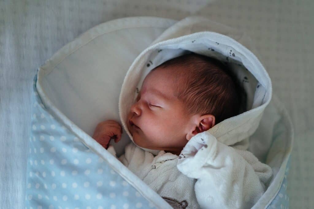 newborn spitting up clear liquid hours after eating